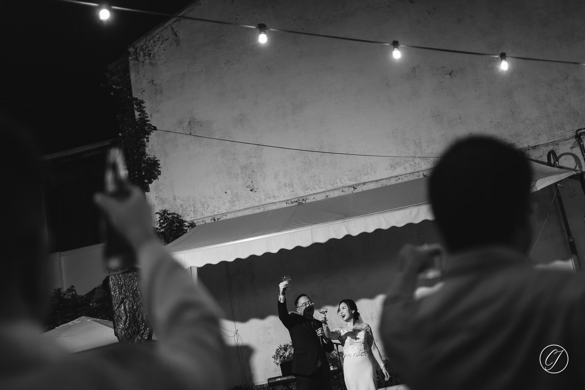 Toasting to the guest on the stage by the couple