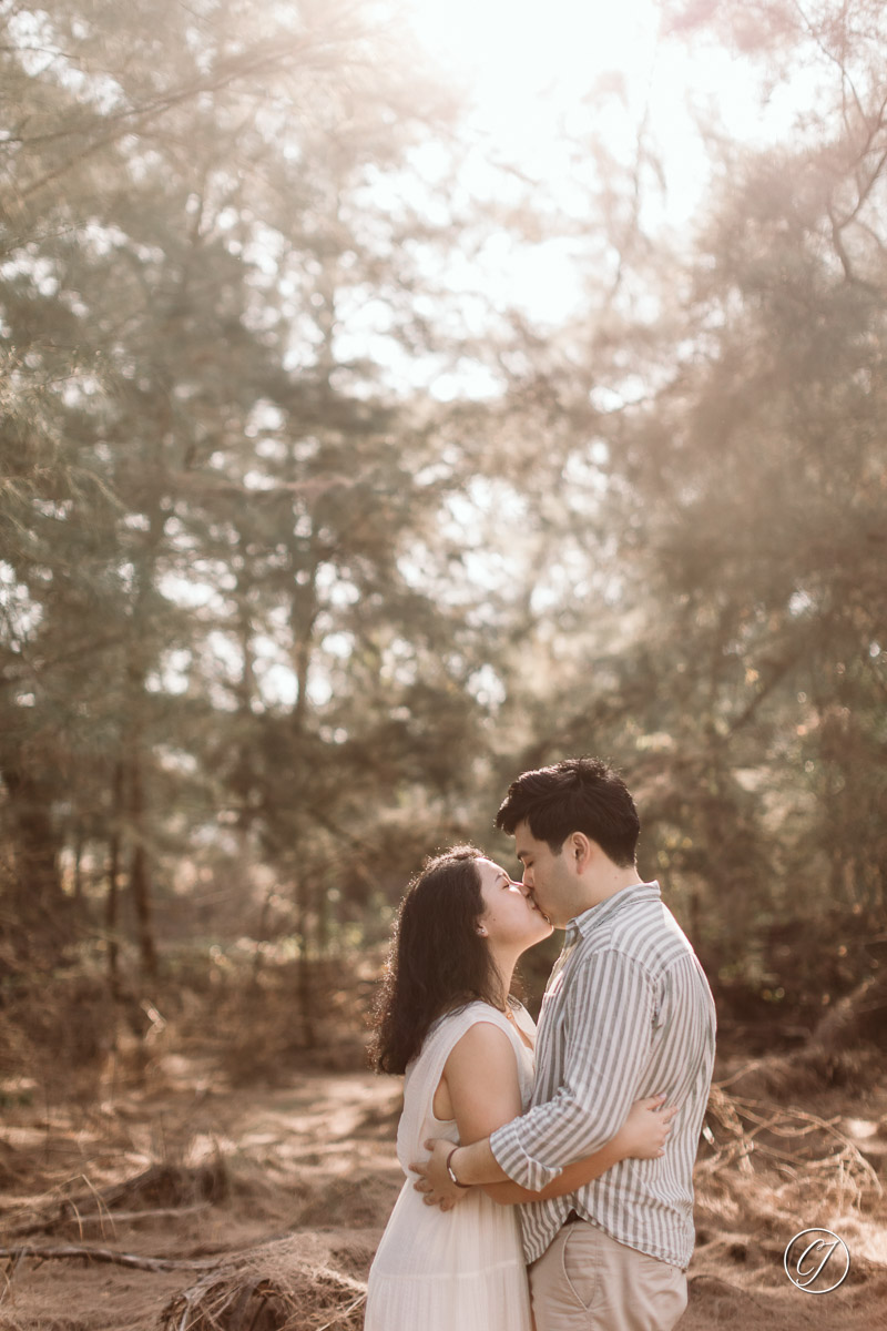 Gentle kiss with backlit in the woods